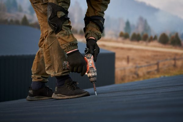 builder-installing-corrugated-iron-sheet-used-as-f-2025-01-16-23-27-51-utc-scaled.jpg